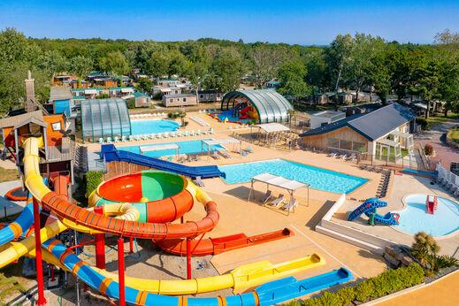 Une vue aérienne dun parc aquatique avec des toboggans, des piscines et des jeux pour enfants.