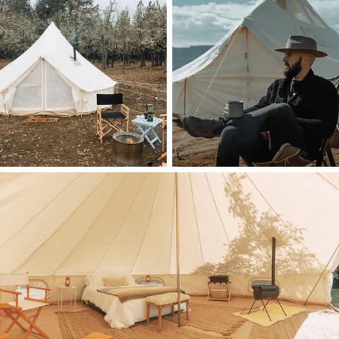 Une tente de luxe avec un lit, un poêle et un coin salon.